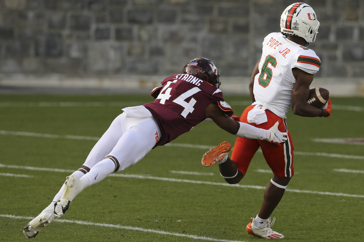 Mark Pope of Miami, right, runs towards the end zone for the game-winning score past Virginia T ...