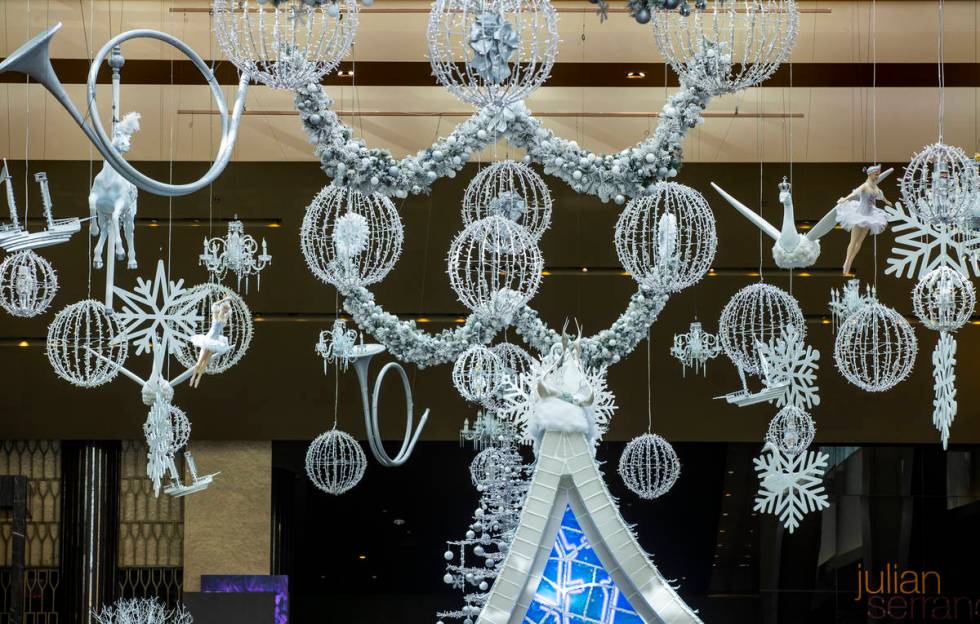 Lighting and decorations hang from the ceiling as part of the Aria's Sugar Palace lobby display ...