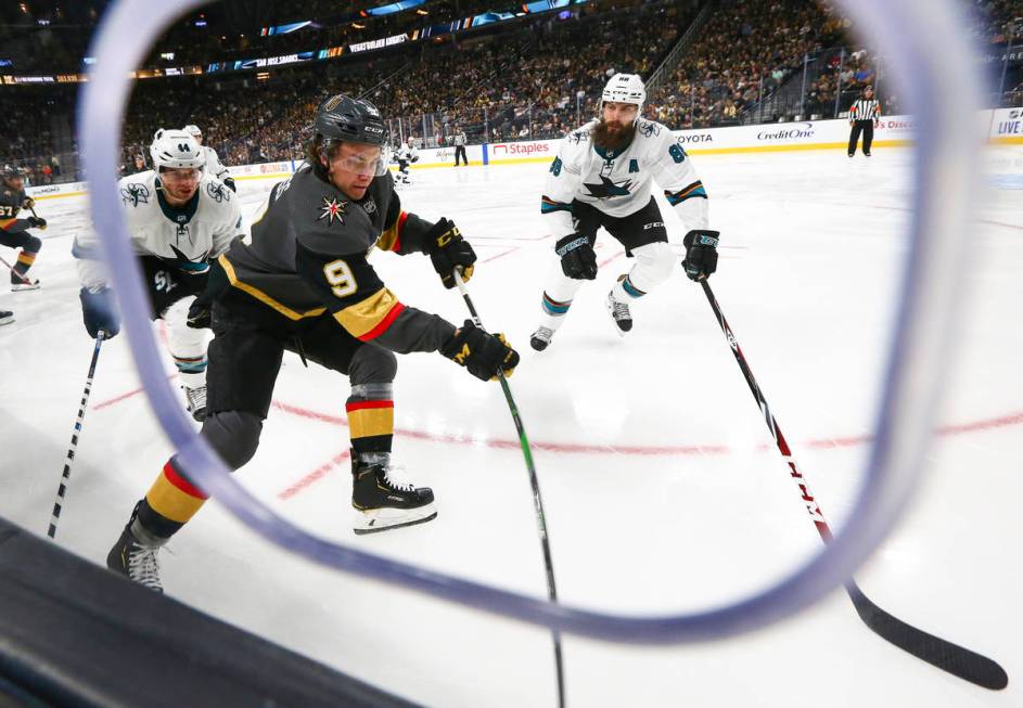 Golden Knights' Cody Glass (9) moves the puck against San Jose Sharks' Brent Burns (88) during ...