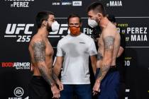 Opponents Mike Perry, left, and Tim Means face off during the UFC 255 weigh-in at UFC APEX on N ...