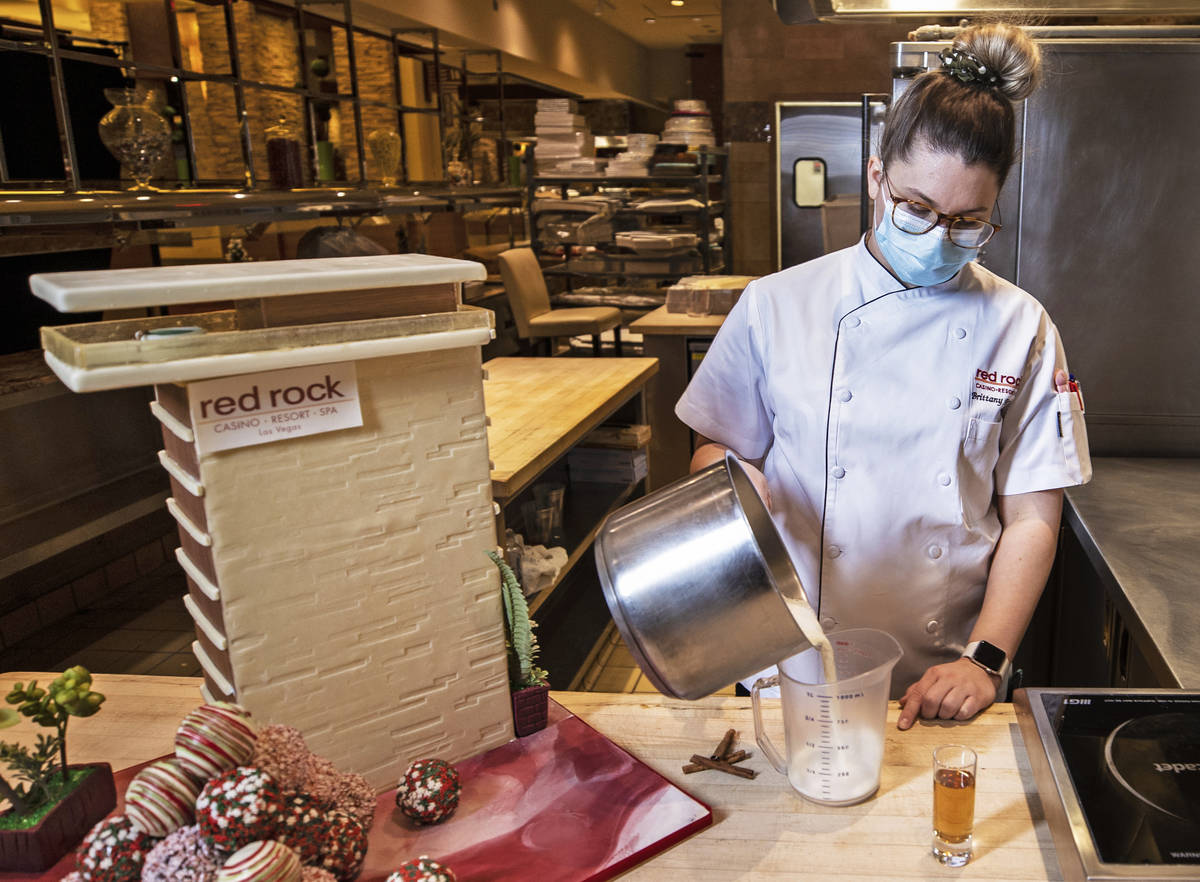 Pastry chef Brittany Simmons measures out 8 oz. of boiling milk in preparation to make a hot co ...