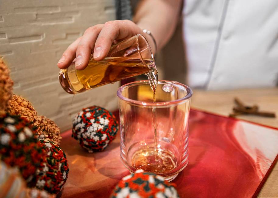 Pastry chef Brittany Simmons pours 2 oz. of Captain Morgan Gingerbread Rum into a coffee mug in ...