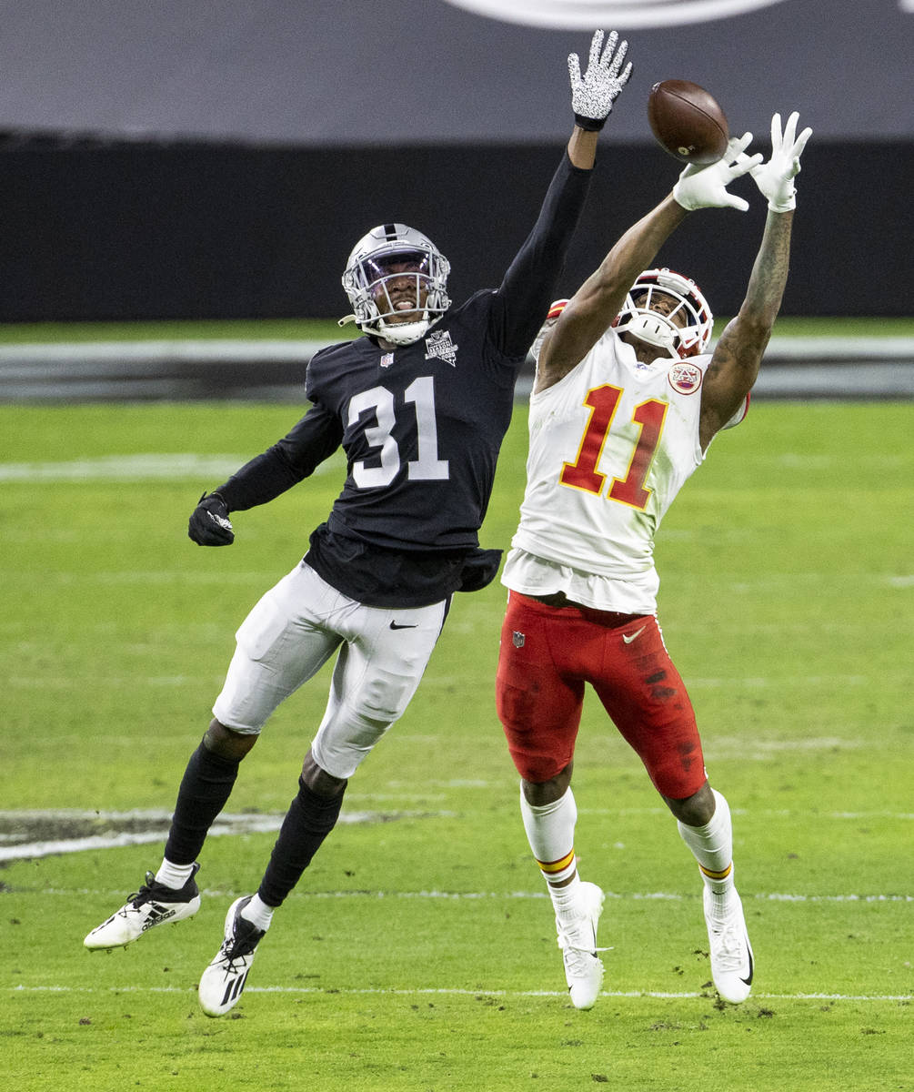 Las Vegas Raiders cornerback Isaiah Johnson (31) disrupts a pass attempt to Kansas City Chiefs ...