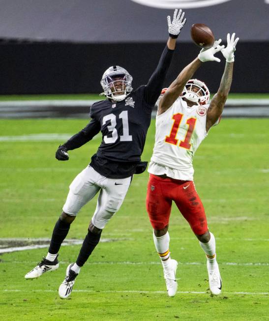 Las Vegas Raiders cornerback Isaiah Johnson (31) disrupts a pass attempt to Kansas City Chiefs ...