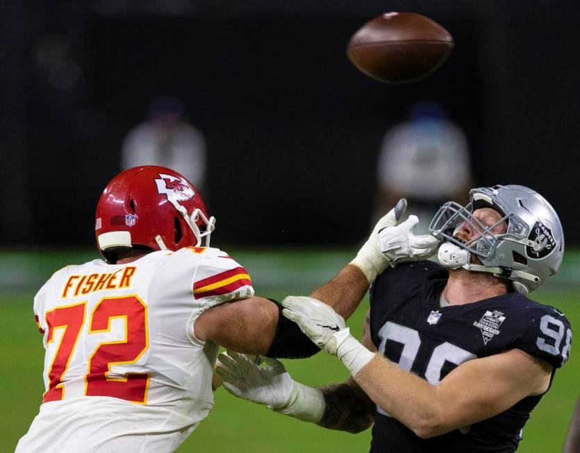 Las Vegas Raiders defensive end Maxx Crosby (98) hand fights with Kansas City Chiefs offensive ...