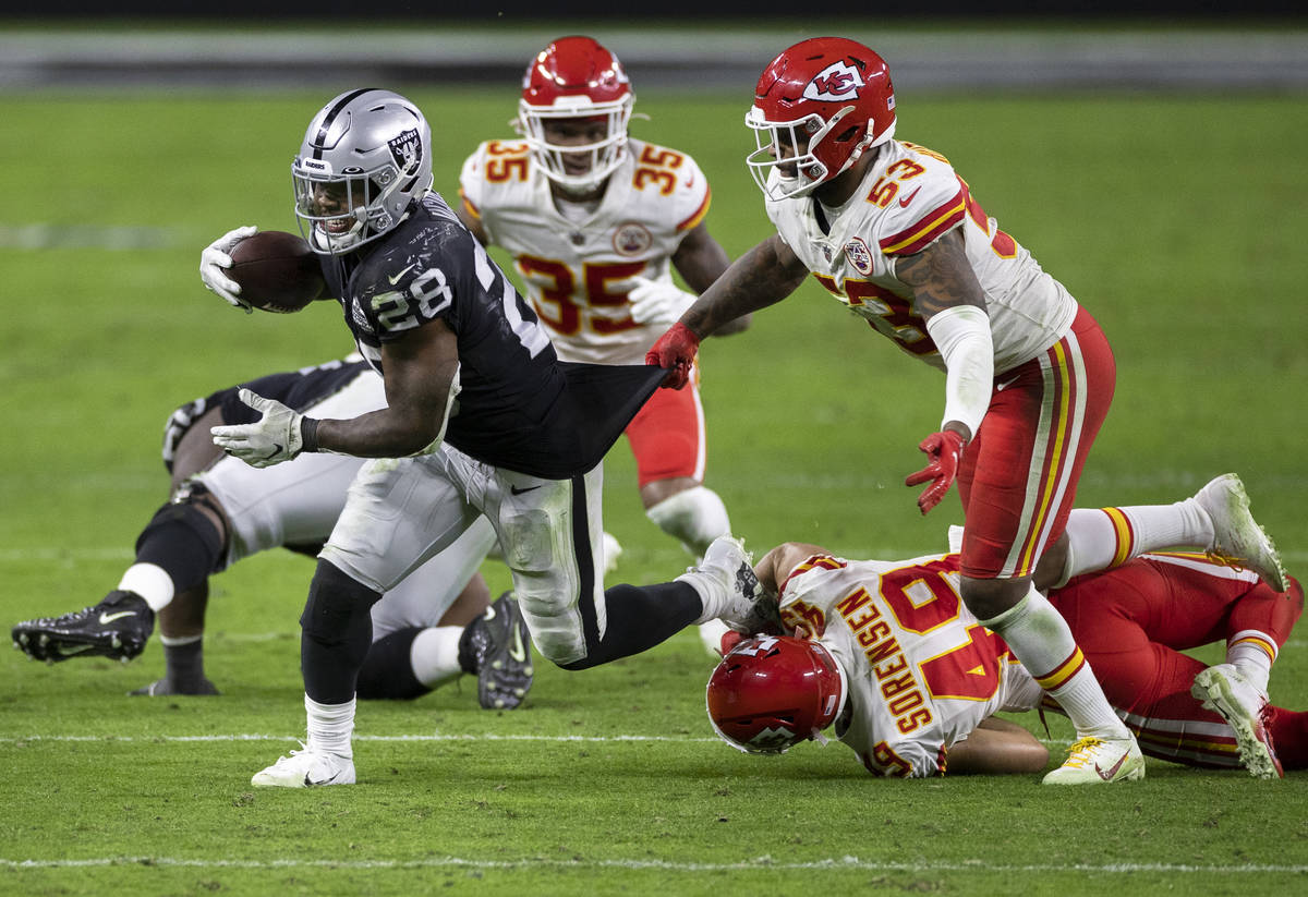 Las Vegas Raiders running back Josh Jacobs (28) runs past Kansas City Chiefs inside linebacker ...