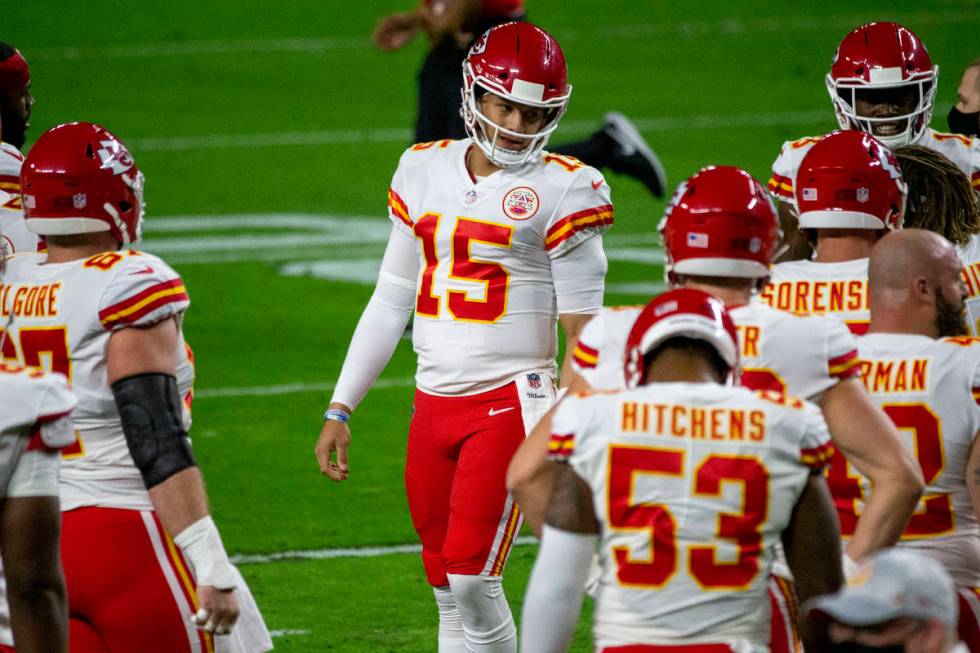 Kansas City Chiefs quarterback Patrick Mahomes (15) talks to his teammates before an NFL footba ...