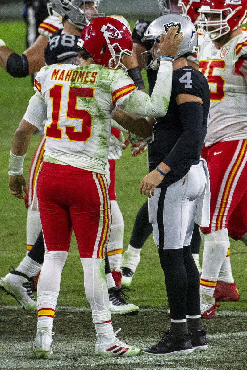 Kansas City Chiefs quarterback Patrick Mahomes (15) pats Las Vegas Raiders quarterback Derek Ca ...