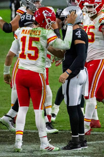 Kansas City Chiefs quarterback Patrick Mahomes (15) pats Las Vegas Raiders quarterback Derek Ca ...