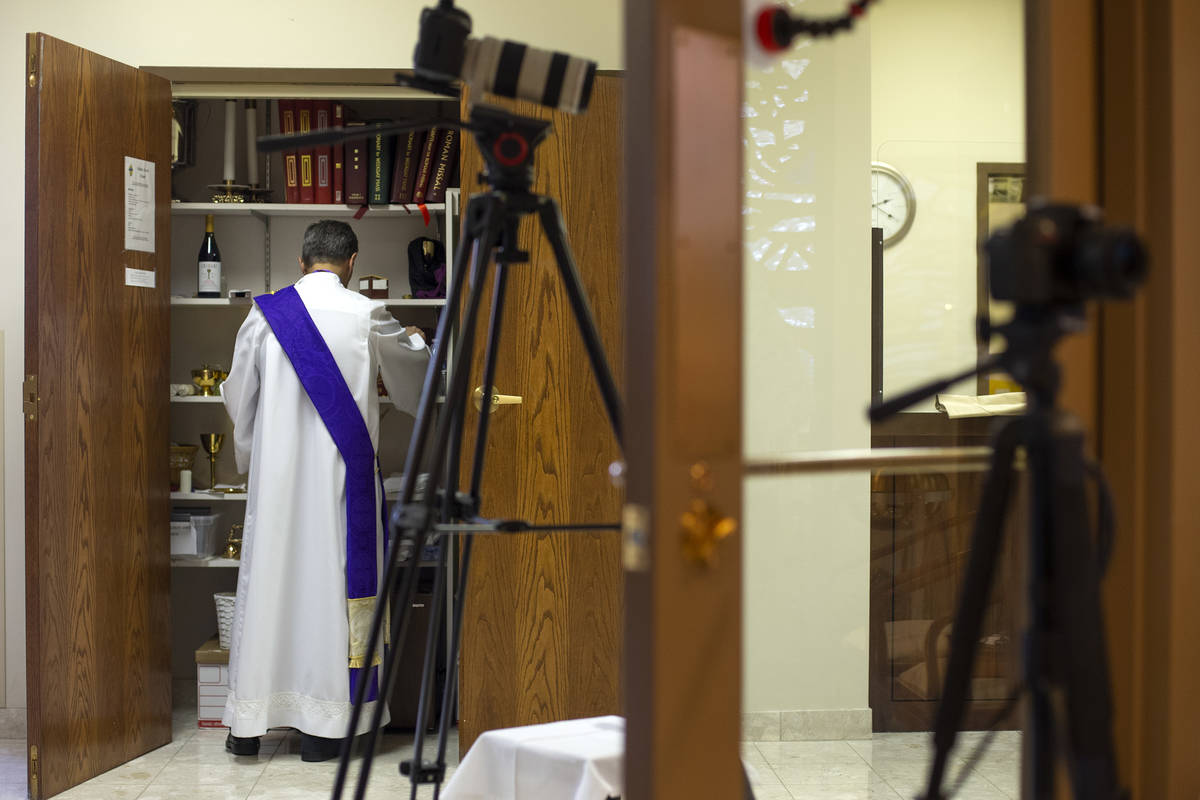 Deacon Rick Minch readies for a virtual Mass at the The Roman Catholic Diocese of Las Vegas on ...