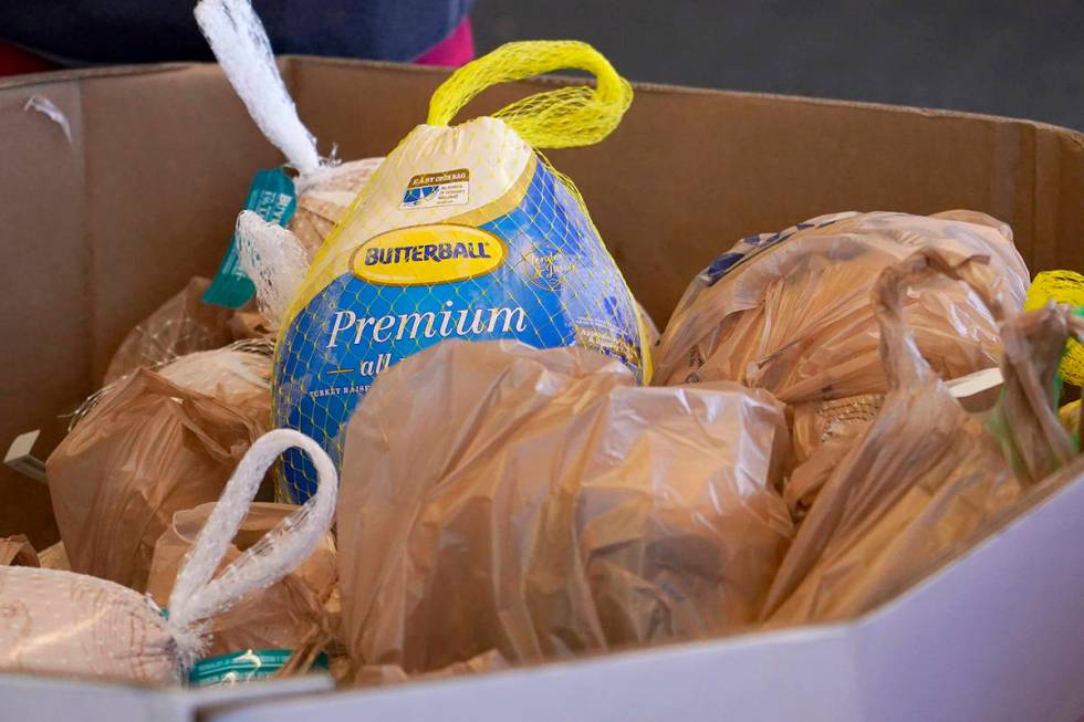 Forty five donated frozen turkeys await collection at this north Jackson, Miss., Kroger grocery ...