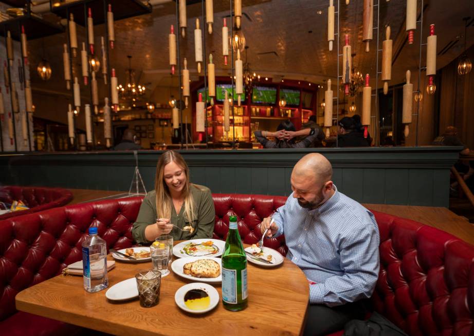 Tourists from Orange County Lauren McLane, 27, left, and John Paton, 28, dine at Buddy V's Rist ...