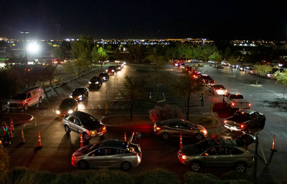 Hundreds of cars line up for Hope for the City's drive-through food pantry and holiday celebrat ...