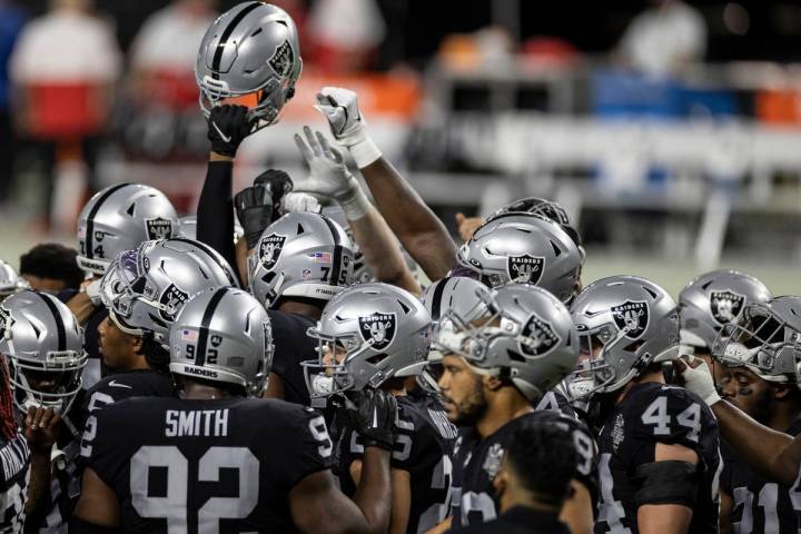 The Las Vegas Raiders warm up before the start of an NFL football game against the Kansas City ...