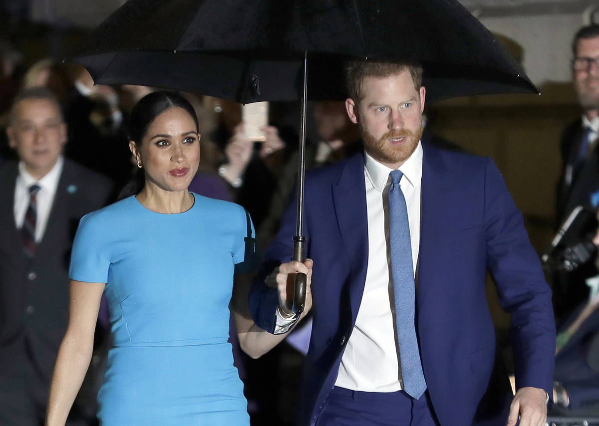 FILE - Prince Harry and Meghan, the Duke and Duchess of Sussex arrive at the annual Endeavour F ...