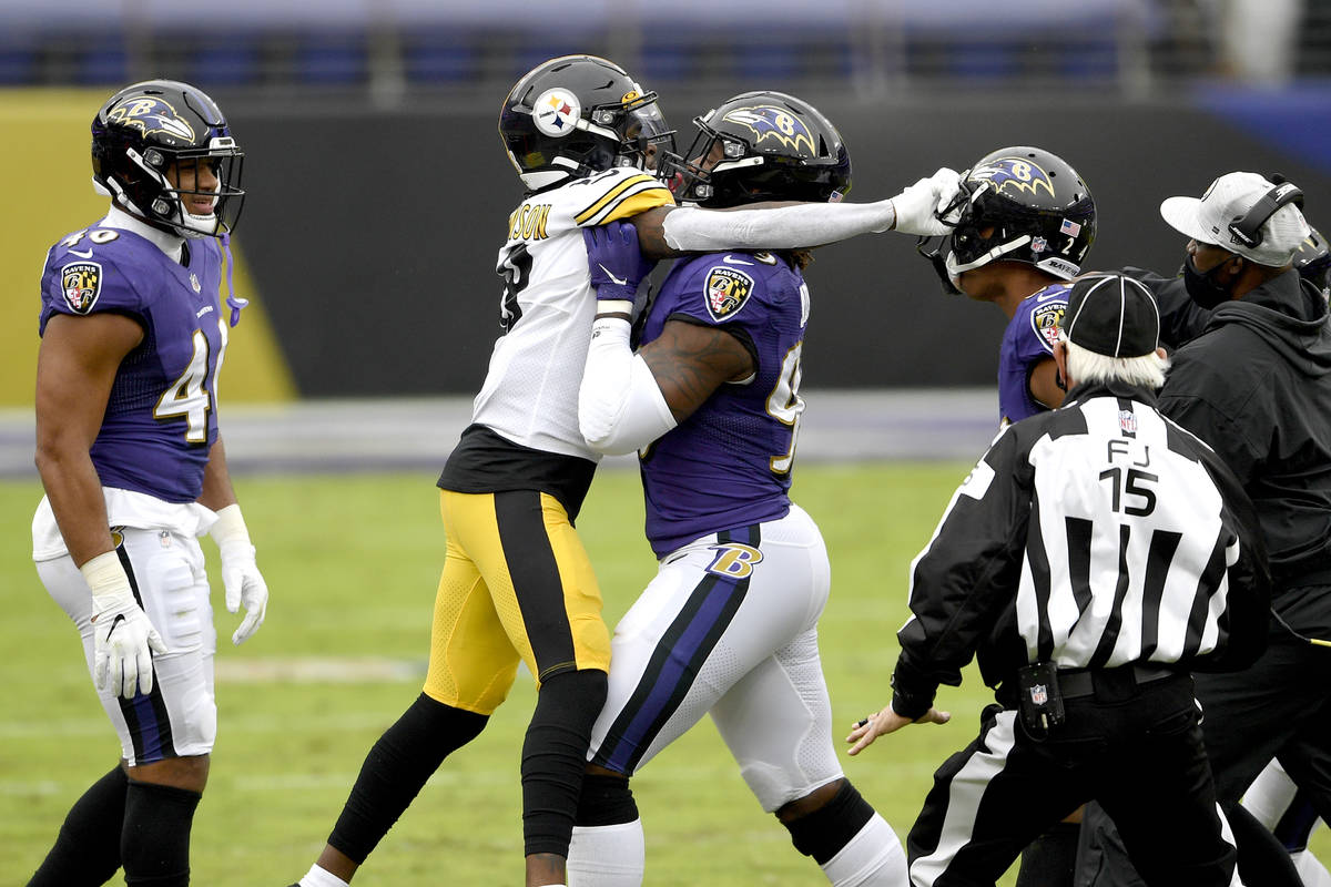 Baltimore Ravens outside linebacker Matt Judon, center, pushes Pittsburgh Steelers wide receive ...