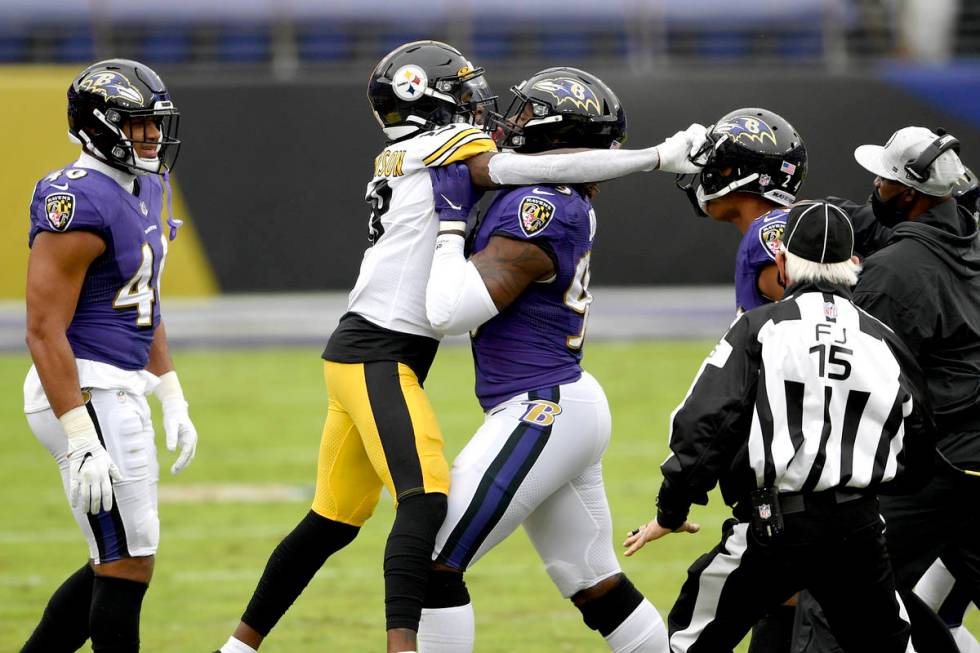 Baltimore Ravens outside linebacker Matt Judon, center, pushes Pittsburgh Steelers wide receive ...