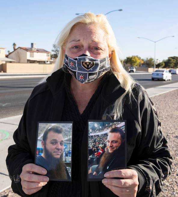 Jennifer Krause holds her son Brandon Krause's photographs as she visits Krause's makeshift mem ...