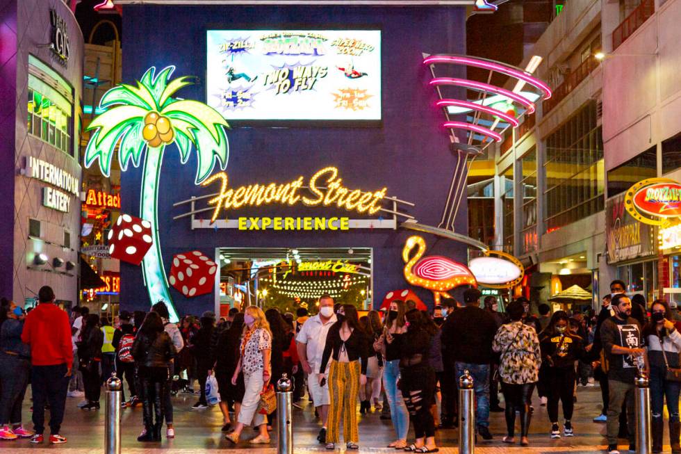 People walk along the Fremont Street Experience in downtown Las Vegas on Saturday, Nov. 21, 202 ...