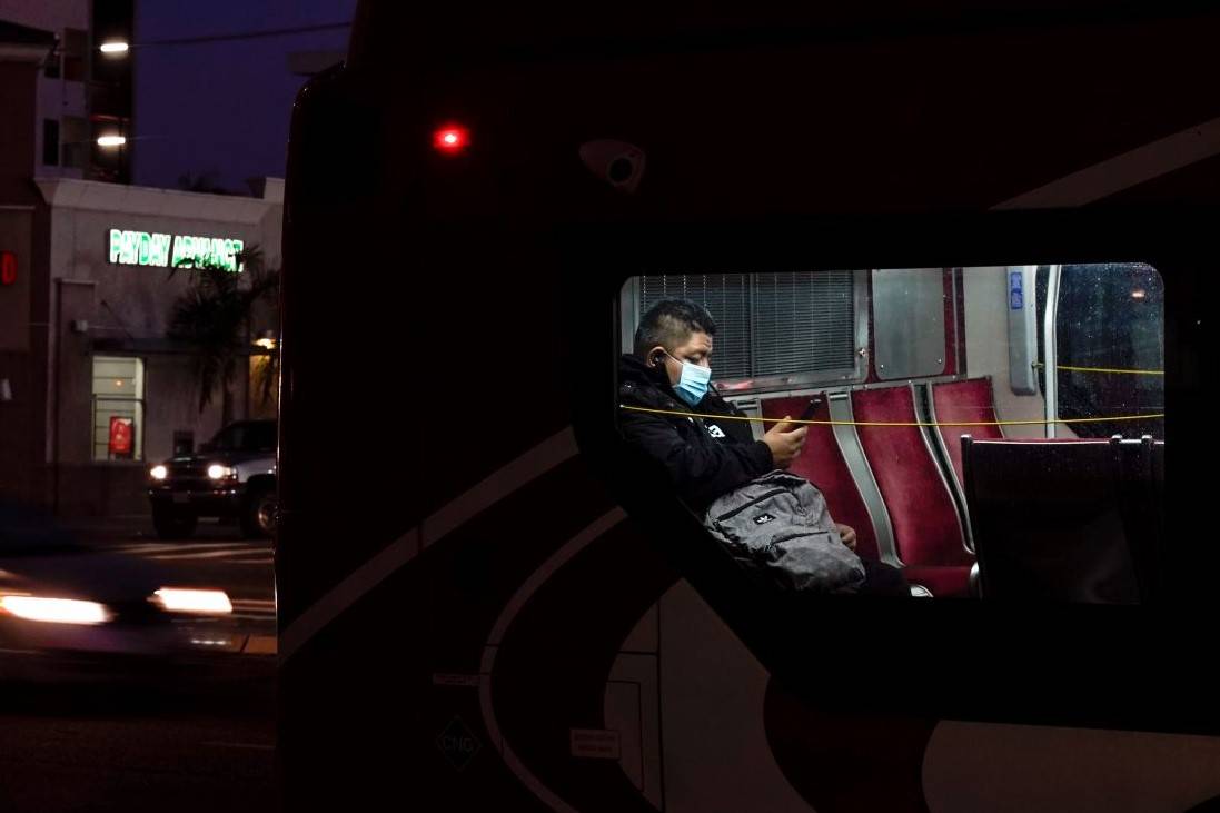 A person wears a mask to prevent the spread of coronavirus on a city bus Tuesday, Nov. 24, 2020 ...