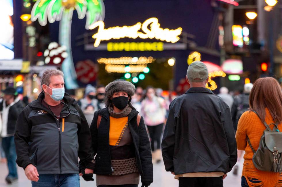 Visitors to Fremont Street Experience dress for cool temperatures on Thursday, Nov. 26, 2020, i ...