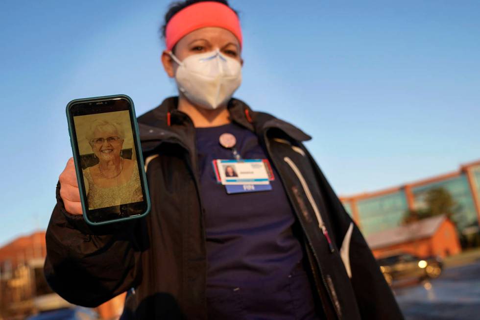 Nurse Jessica Franz, shows a photo of her mother-in-law, Elaine Franz, outside Olathe Medical C ...