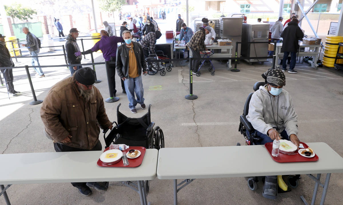 Robert Johnson and Atrina Phillips settle in for a free Thanksgiving meal at the new outdoor di ...