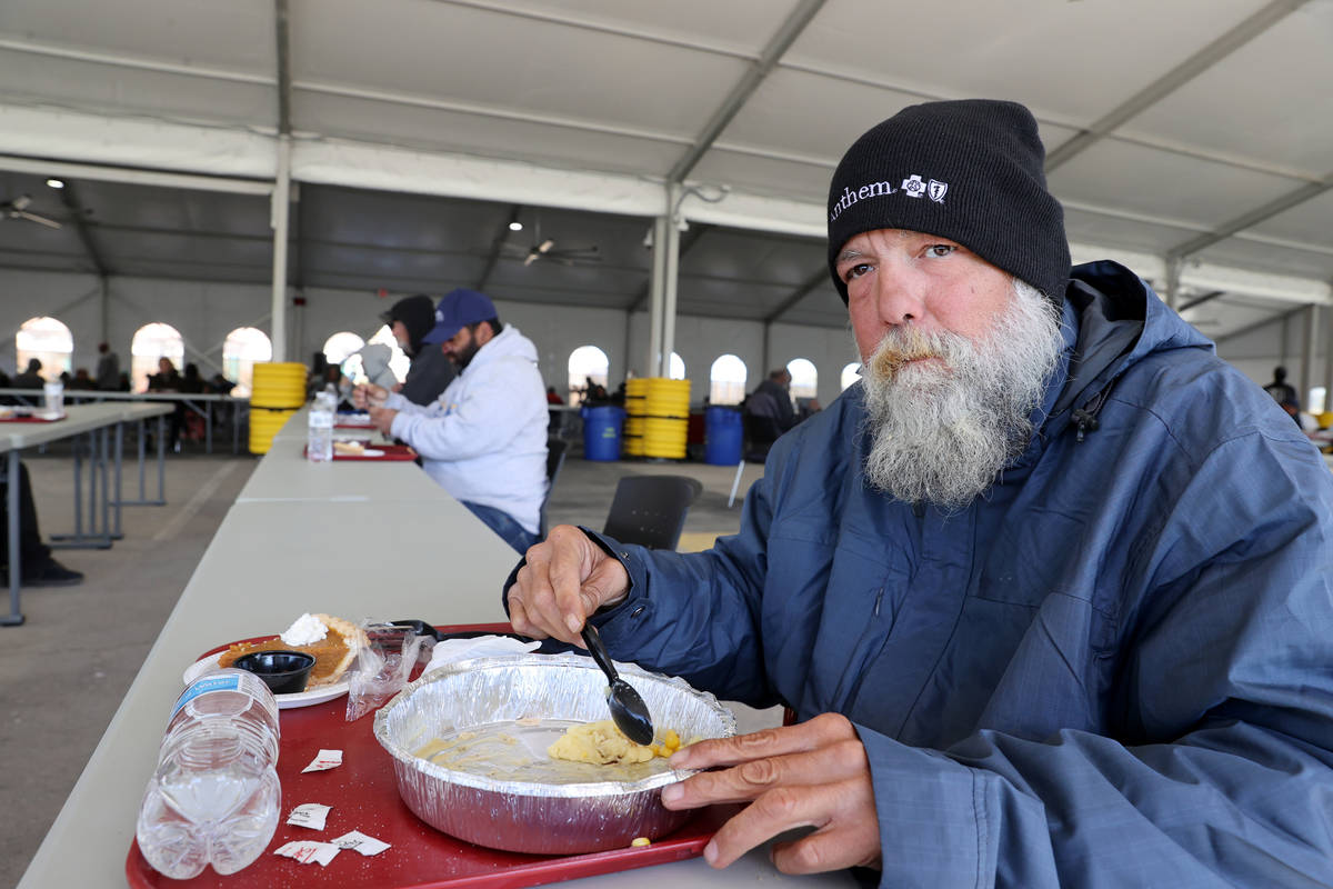 Clients, including Nathan Shapiro, 56, right, eat a socially distanced Thanksgiving meal at the ...