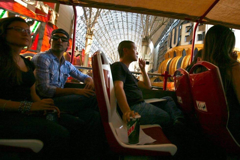 Tony Hsieh, center,CEO of of online clothing maker Zappos.com, during Big Bus downtown tour, T ...