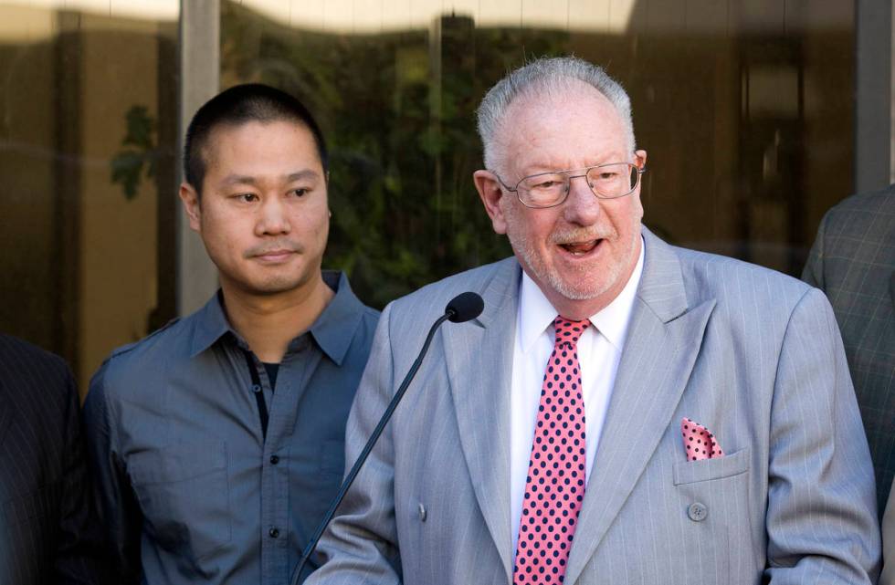 Tony Hsieh, left, CEO of Zappos a subsidiary of Amazon.com, looks on as Las Vegas Mayor Oscar G ...