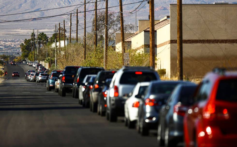 People wait in line at the drive-thru COVID-19 testing site at Texas Station in North Las Vegas ...