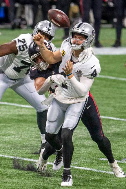 Atlanta Falcons defensive tackle Jacob Tuioti-Mariner (91) forces a fumble as Las Vegas Raiders ...