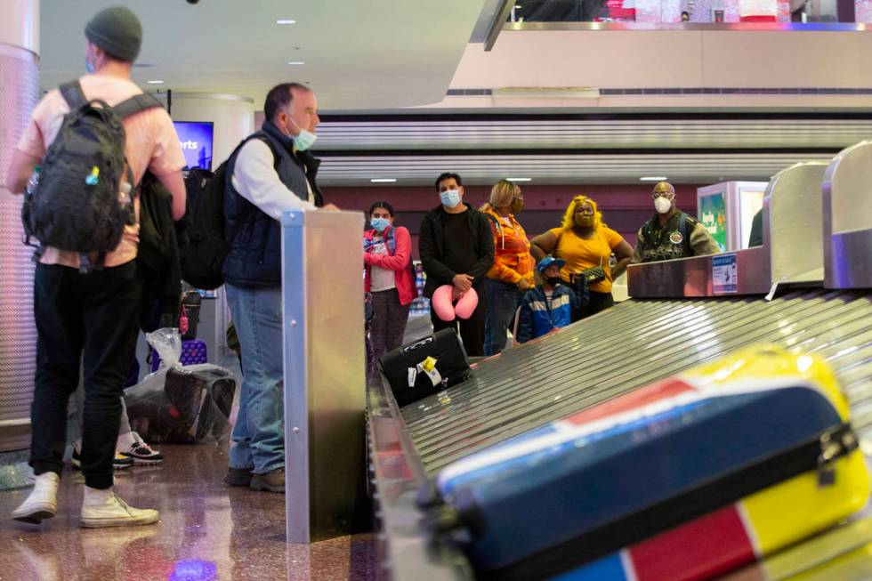Visitors wait for their luggage ahead of the Thanksgiving holiday at McCarran International Air ...