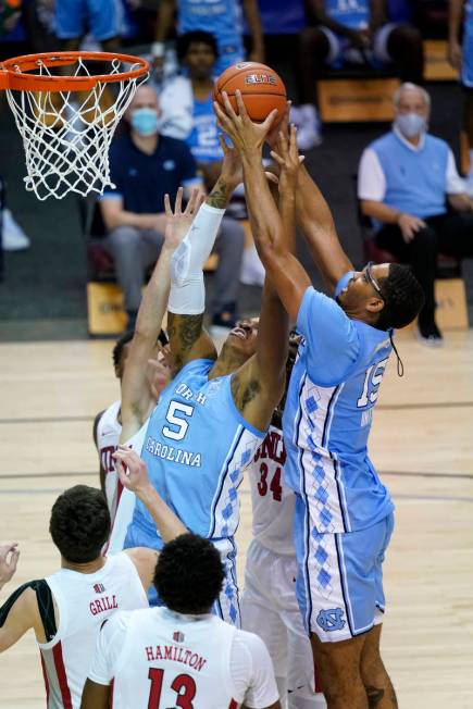 North Carolina forward Armando Bacot (5) and forward Garrison Brooks (15) leap for a rebound ag ...