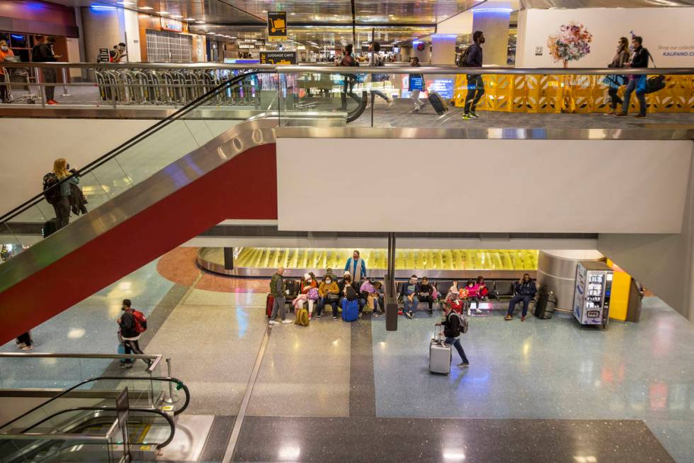 People come and go at Terminal 1 as holiday travel at McCarran International Airport continues ...