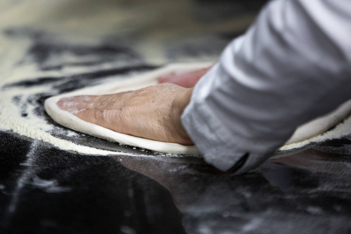 Chef Floriana Pastore kneads her grandmother's dough recipe into a pizza at her food truck, Sig ...