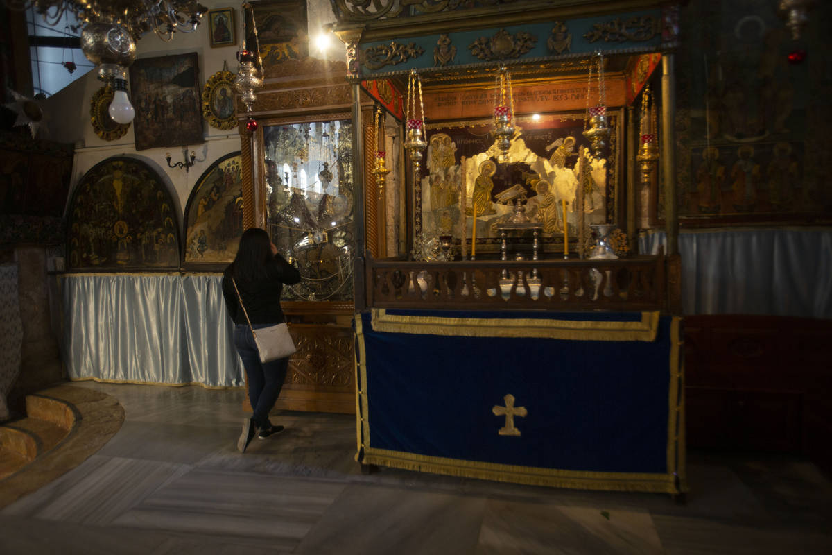 Christian worshiper prays in the Church of the Nativity, traditionally believed to be the birth ...