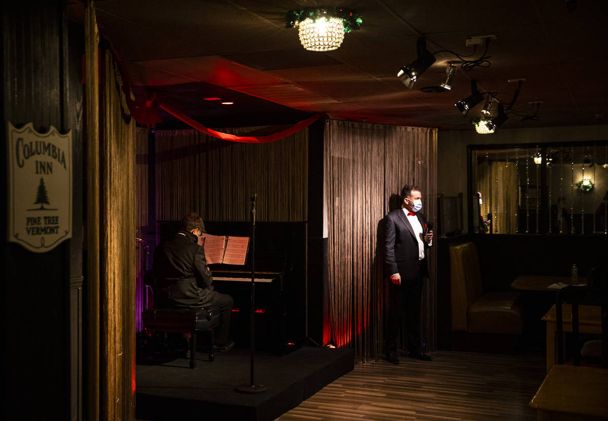 Sam Holder, right, prepares to perform during rehearsal for "A Vegas Room Christmas" ...