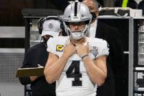 Las Vegas Raiders quarterback Derek Carr (4) watches the team play from the sideline during the ...