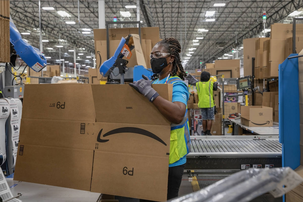 Amazon associate Lola Wickett packages products at AmazonÕs warehouse in North Las Vegas o ...