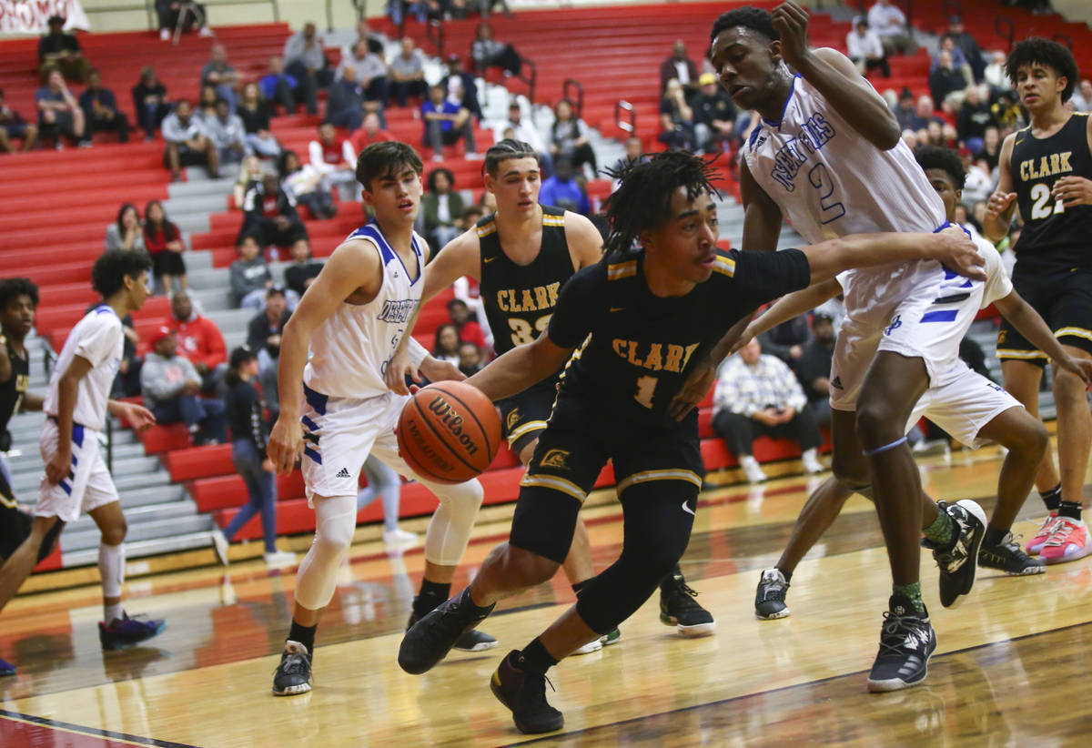 Clark's Frankie Collins (1) moves the ball around Desert Pines' Dayshawn Wiley (2) during the f ...