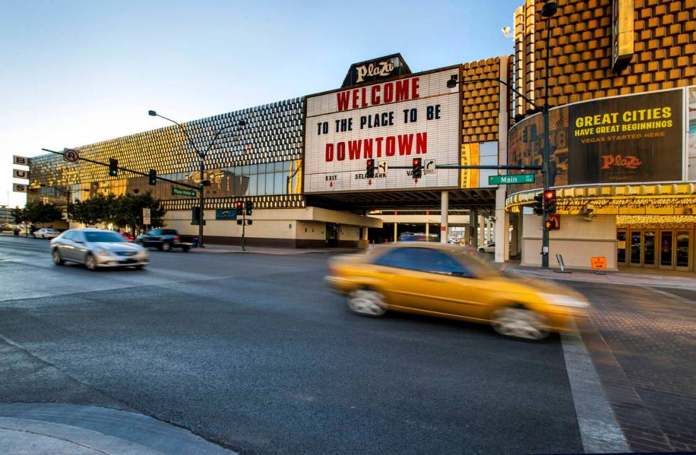 Cars stream past the current Greyhound bus terminal building downtown which the Plaza Hotel and ...