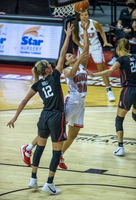 UNLV Lady Rebels guard Nia Johnson (30) lays in a basket past Stanford Cardinal guard Lexie Hul ...