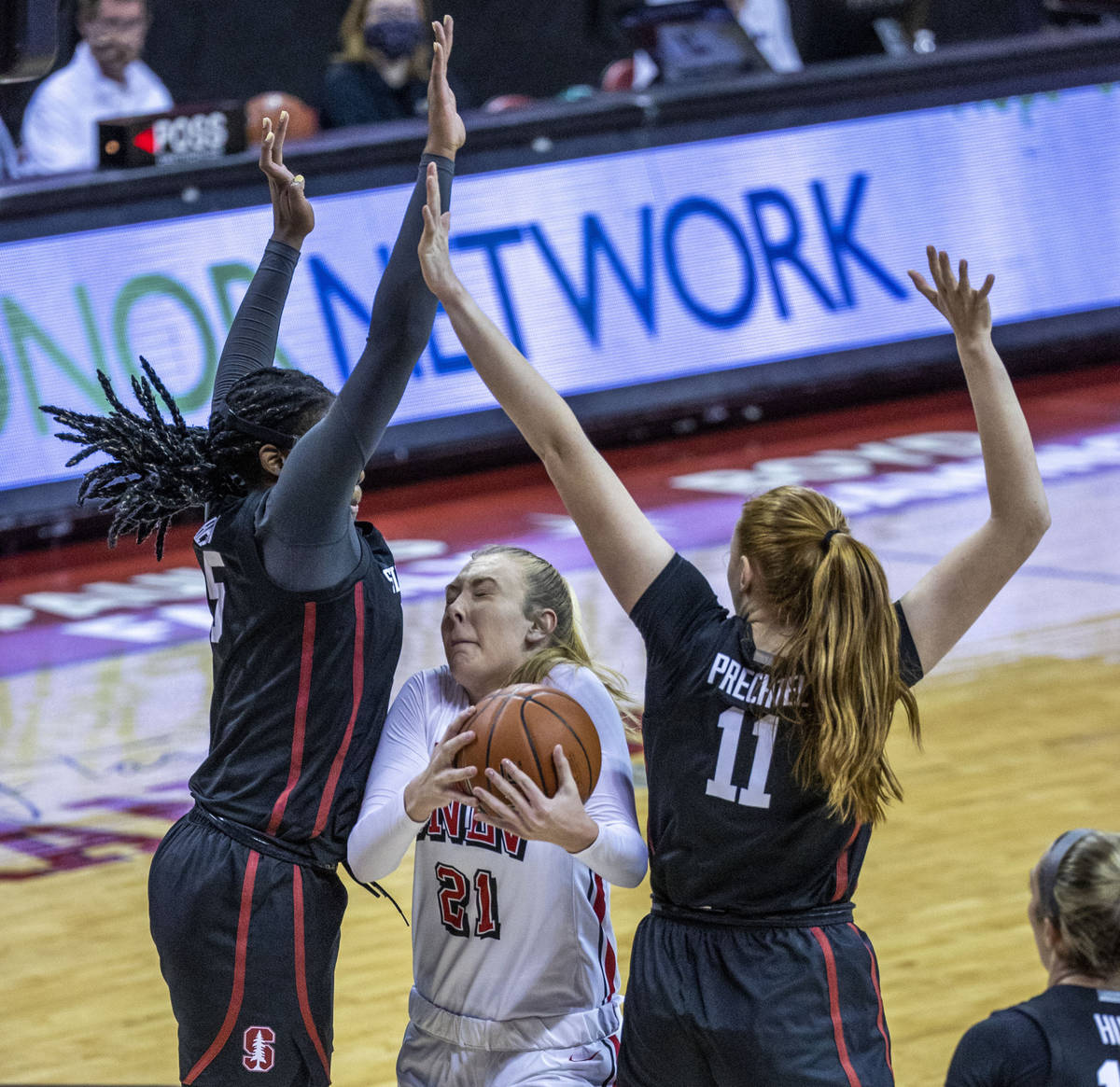 UNLV Lady Rebels forward Delaynie Byrne (21, center) ducks between Stanford Cardinal forward Fr ...