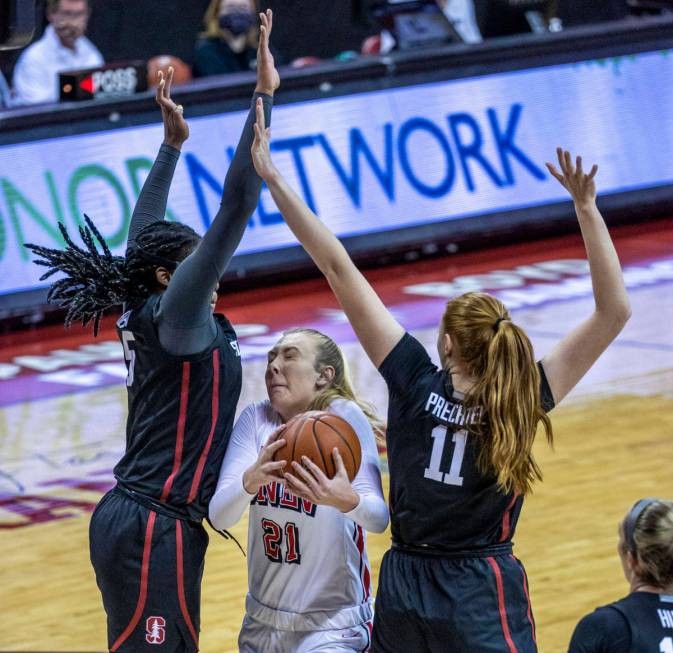 UNLV Lady Rebels forward Delaynie Byrne (21, center) ducks between Stanford Cardinal forward Fr ...