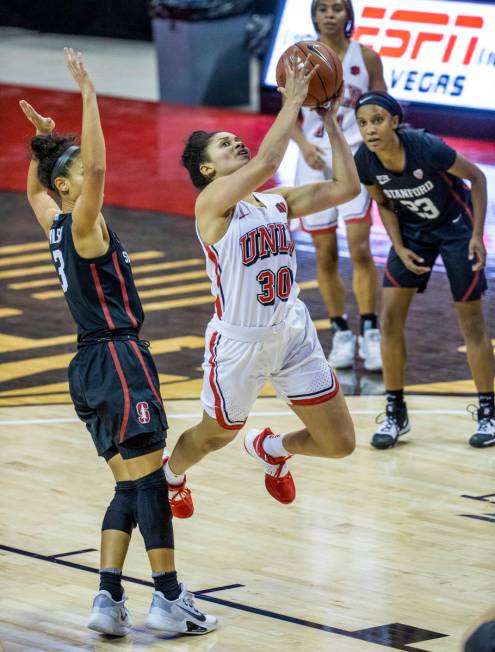 UNLV Lady Rebels guard Nia Johnson (30, center) eyes a shot after passing by Stanford Cardinal ...