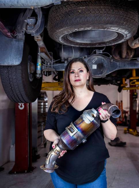 Danielle Vila, co-owner of Red Rock Repair, holds a recently removed catalytic converter at the ...