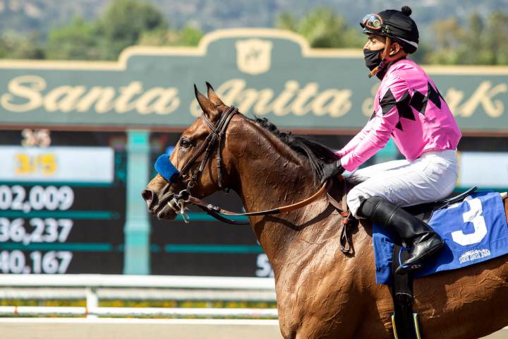 In this image provided by Benoit Photo, Abel Cedillo, top, leads Fighting Mad to the Winner's C ...