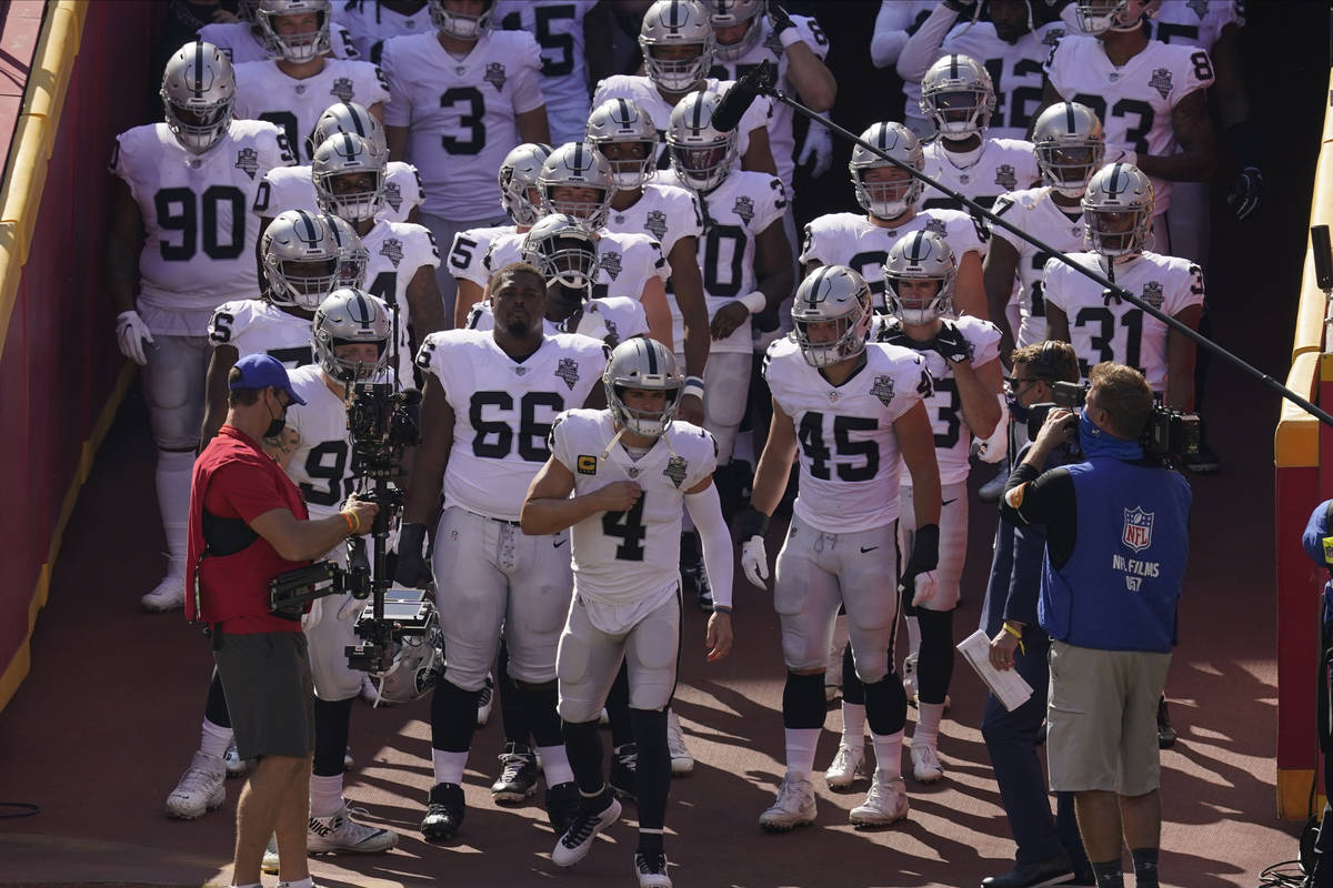 Las Vegas Raiders quarterback Derek Carr (4) leads the team onto the field before an NFL footba ...