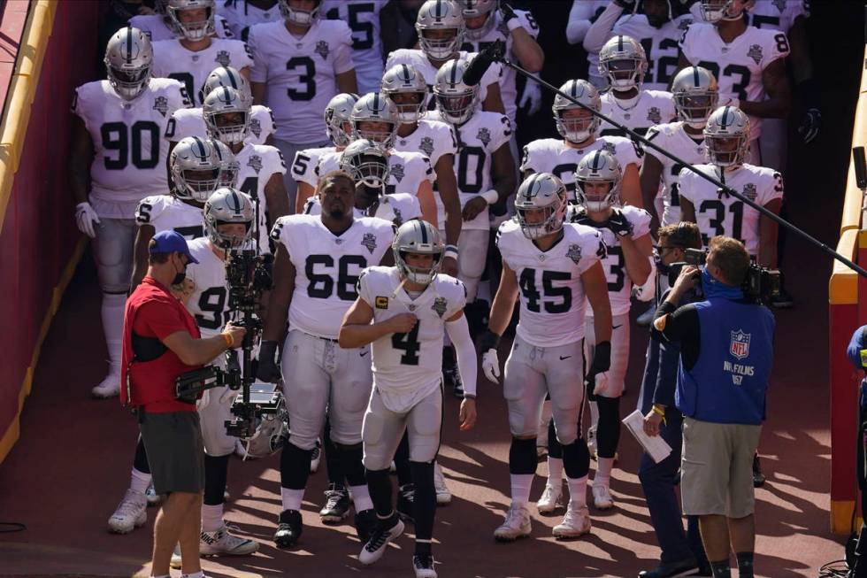 Las Vegas Raiders quarterback Derek Carr (4) leads the team onto the field before an NFL footba ...